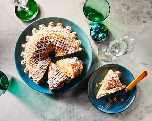 Almond Kringle pastry with sliced almonds and holiday table setting