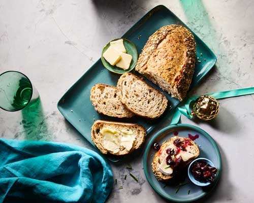 Prairie Harvest Multigrain Bread loaf sliced on rustic board