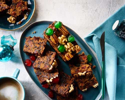 Fruit Cakes with mixed dried fruit and marzipan icing on festive table